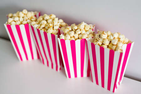 close up of popcorn in red striped boxes on the tableの写真素材