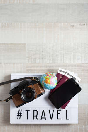 travel and vacation concept - top view of travel objects over wooden background with copy spaceの写真素材