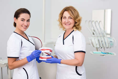 portrait of two female dentists posing in modern dental clinic