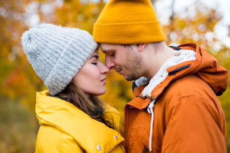 close up portrait of cute beautiful couple in love in autumn park or forestの写真素材
