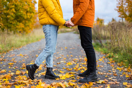 autumn and love concept - close up of young couple in love posing in autumn parkの写真素材