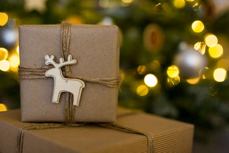 christmas background - close up of gift box under decorated christmas treeの写真素材