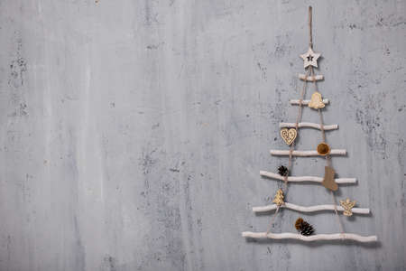 artificial christmas tree and copy space over grey concrete wall backgroundの写真素材