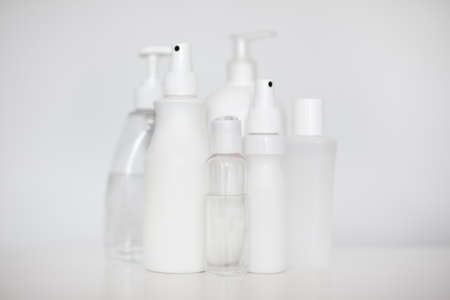 many different hand sanitizer bottles over white background