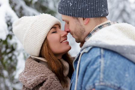 close up portrait of cute couple in love hugging in winter forestの写真素材
