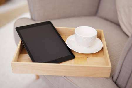 wooden tray with empty cup and modern tablet pc with blank screenの写真素材
