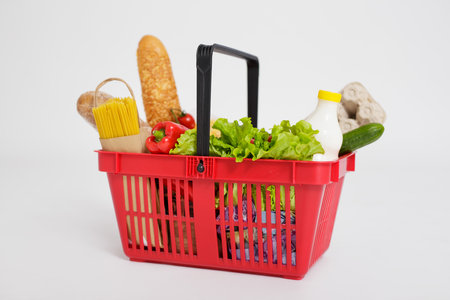 close up of shopping basket full of healthy food over white backgroundの写真素材