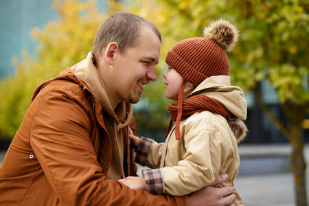 family, love and happiness concept - close up portrait of young father and little daughter in autumn...