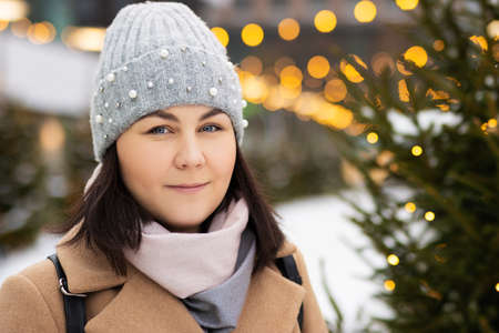 Close up portrait of woman in city with illuminationの写真素材
