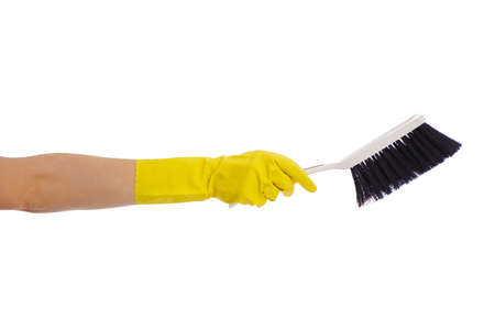 housekeeping concept - hand in yellow rubber glove holding plastic brush isolated on white...