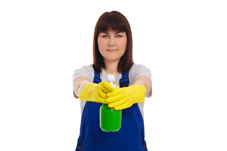 portrait of professional female cleaner in blue uniform holding detergent spray isolated on white backgroundの写真素材