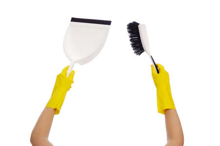 housekeeping concept - hands in yellow rubber gloves holding brush and dustpan isolated on white...
