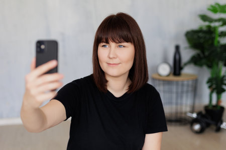 happy young woman taking selfie photo with smartphone before or after training