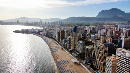 summer and travel concept - beautiful aerial view of beach promenade, mountains and scyscrapers in Benidorm, Spainのeditorial素材