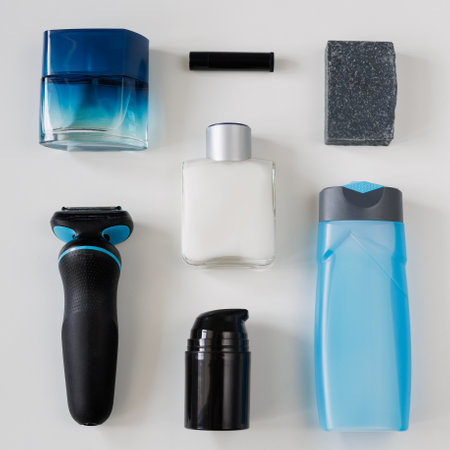 Flatlay of bottles of cosmetic products, soap and razor for men on light background.の写真素材