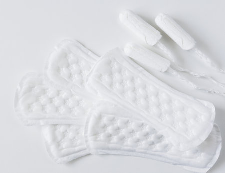 Feminine hygiene protection pads and tampons for woman critical days on white background with copyspaceの写真素材