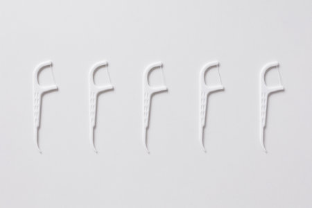 Set of white dental toothpicks with dental floss on white backgroundの写真素材