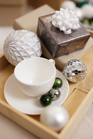 Wooden tray with christmas decor and white cupの写真素材