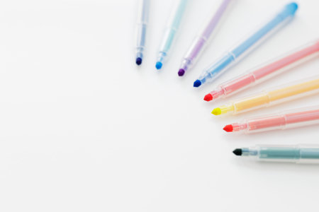 colorful markers and copy space on white table backgroundの写真素材