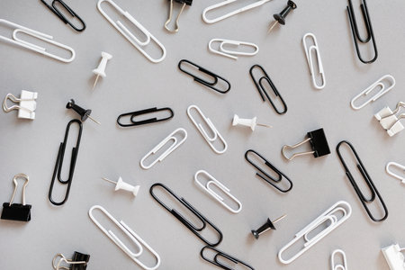 collection of various type of paper clips over grey backgroundの写真素材