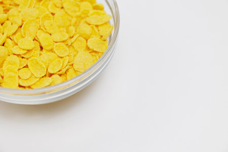 Top view of part of glass bowl with corn flakes with copy spaceの写真素材