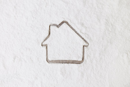 Top view of house made of white flour on wooden backgroundの写真素材