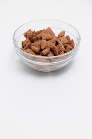 Sweet crispy corn pads in glass bowl on white with copyspaceの写真素材