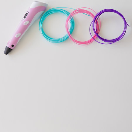 3d pen and kit of colourful plastic filament on white table with copyspaceの写真素材