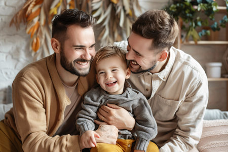 portrait of happy gay couple with little son at homeの素材