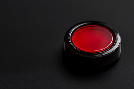 close up of red button on the black background with copy spaceの素材