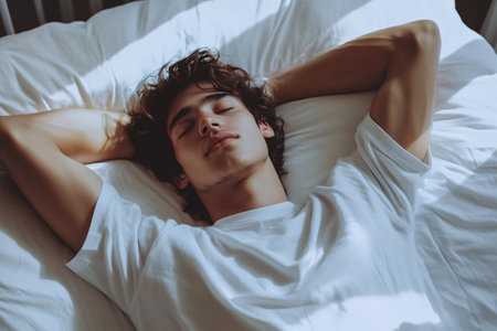 portrait of young handsome man sleeping on bed at homeの素材