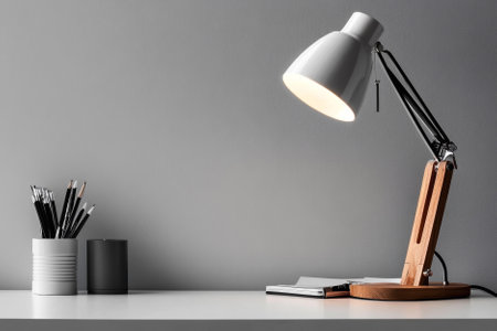 modern desk lamp on white table over white textured background with copy space. Interior design conceptの素材