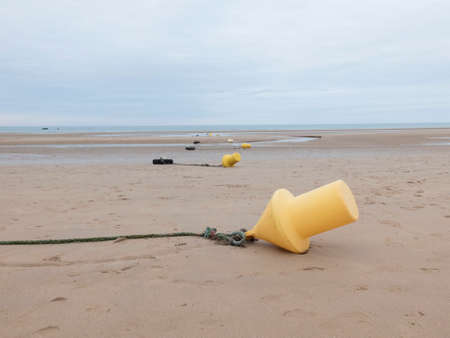 signaling buoys high tide lying on the seabedの写真素材