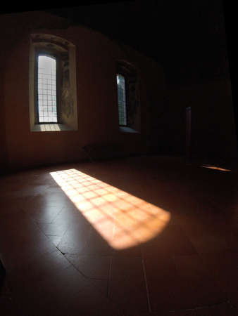 The light filters through the window of a castleの写真素材