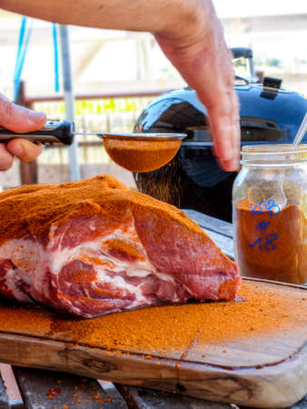 Dust the pork with a mixture of spices to prepare the pulled porkの写真素材