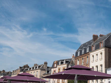 Glimpse of typical Normandy buildings with purple umbrellasの写真素材