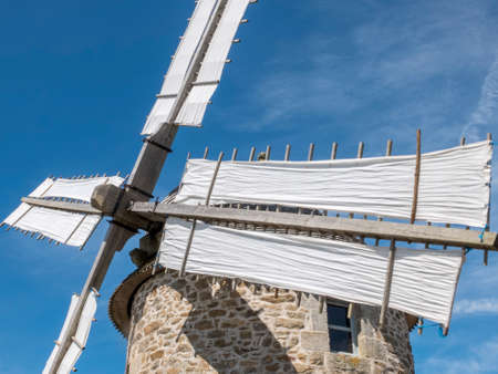 Les Moulins de Trouguer, ClÃ © den-Cap-Sizun, France - Aug 5, 2016: An old windmill on the coast of Normandy. Stone structure, wooden gears and bare white coated blades.のeditorial素材