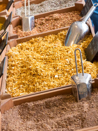 small wooden crates with various types of minced spices and grains: curcuma, curry, cajun, keufta, paprika and various infusions.の写真素材