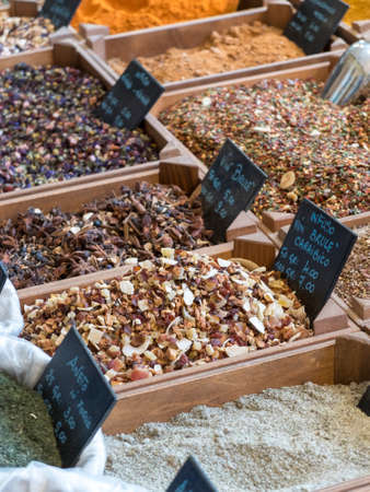 small wooden crates with various types of minced spices and grains: curcuma, curry, cajun, keufta, paprika and various infusions.の写真素材