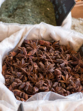 bags on display on stand with different spices. In star anise starred by the typical star shapeの写真素材