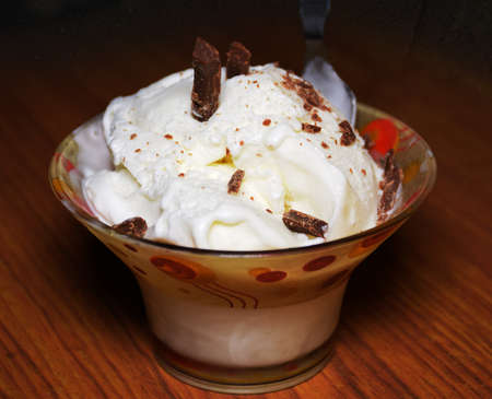 Delicious Vanilla Ice cream served in a glass cup with chocolate topping
