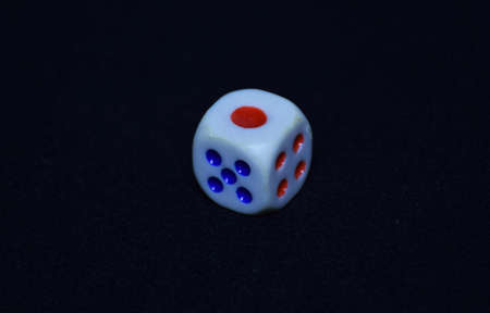 Closeup of a colored Dice. Dice are small, throwable objects with marked sides that can rest in...