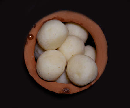 Bengali sweet Rasgulla top angle view kept in a traditional earthen potの写真素材