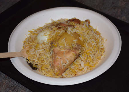 Delicious Indian Chicken Biryani served in a white paper plateの写真素材
