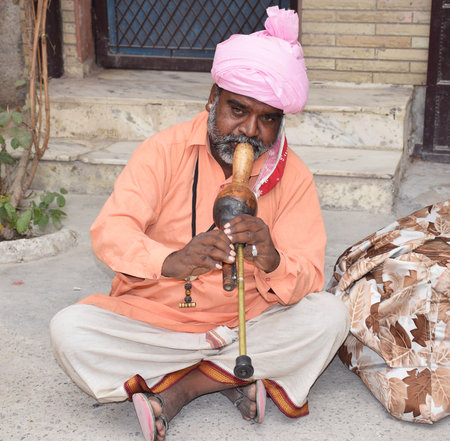 Indian Snake charmer performing with his musical instrument also called as Pungi or Been in Hindi Languageのeditorial素材