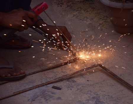 Hand of an Indian technician or worker welding a Iron Window Grillの写真素材