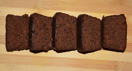 Home made Dark Plum Cake pieces made during christmas on a wooden backgroundの写真素材