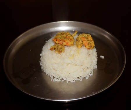 Mustard Prawns over white rice served on a steel plate. It is an Indian Bengali dishの写真素材
