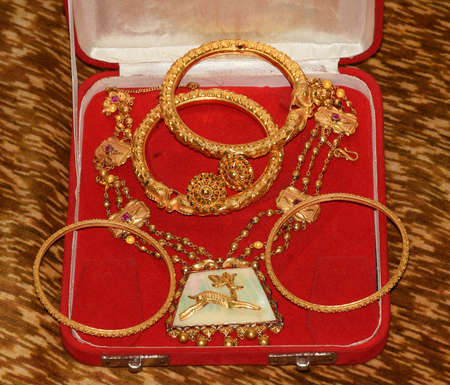 Traditional Indian Gold Jewellery items places on a jewellery boxの写真素材