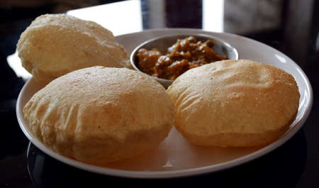 Indian breakfast poori (deep fried bread) at a restaurantの写真素材